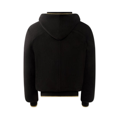 The TECHIN Black Cashmere Hoodie is shown from the back against a white background. It features long sleeves, ribbed cuffs and hem, a loose fit, and thick, plush fabric with no visible logos or patterns. , available at Richard Gelding Mayfair