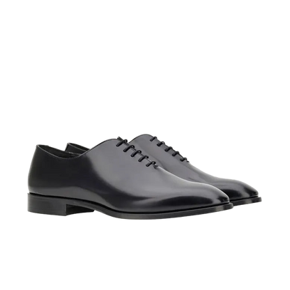 The Canali Black Calf Leather Wholecut Oxford Shoes feature closed lacing, low stacked heels, and smooth rounded toes, shown on a plain white background—an elegant choice for business or special occasions. , available at Richard Gelding Mayfair