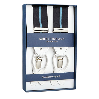 A boxed set of Albert Thurston suspenders, featuring white leather and blue Eton stripe elastic straps, labeled "Handmade in England" and inspired by Gordon Gekko from Wall Street.