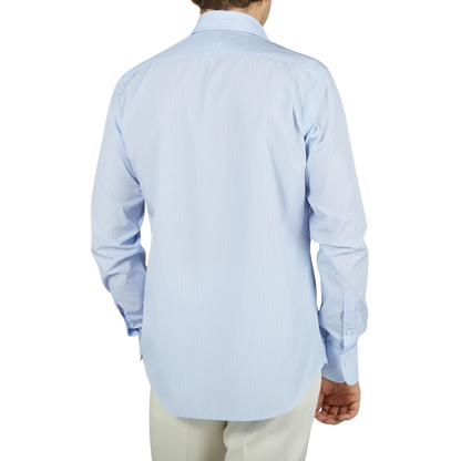 The back view of a man wearing an Alessandro Gherardi Blue Fancy Striped Cotton Single Cuff Shirt.