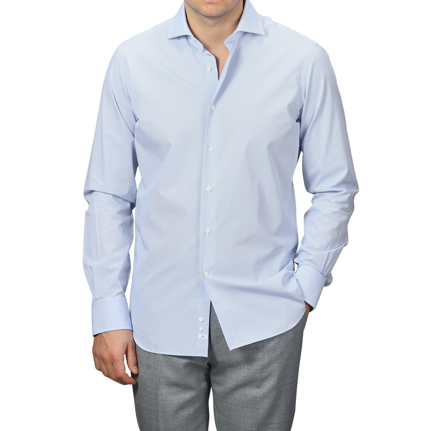 A person stands with one hand in their pocket, wearing an Alessandro Gherardi Blue Gingham Checked Cotton Single Cuff Shirt paired with gray trousers.