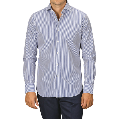 A person wearing an Alessandro Gherardi Dark Blue Striped Cotton Single Cuff Shirt and dark trousers stands against a plain background.