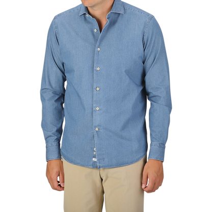 A person wearing an Alessandro Gherardi Light Blue Cotton Denim Single Cuff Shirt and beige pants stands against a plain background. Their head is not visible in the frame.