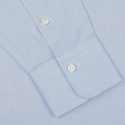 Close-up view of the cuff of an Alessandro Gherardi Light Blue Cotton Oxford Single Cuff Shirt, featuring two white buttons and crafted from pure cotton oxford, on a plain background.