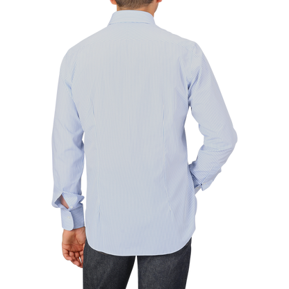 A person wearing an Alessandro Gherardi Light Blue Striped Cotton Single Cuff Shirt and dark jeans, shown from the back against a plain background.