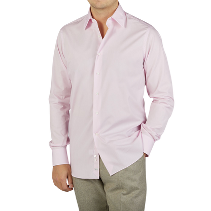 A man wearing a high-quality Alessandro Gherardi Pink Fine Cotton Single Cuff Shirt and slacks.