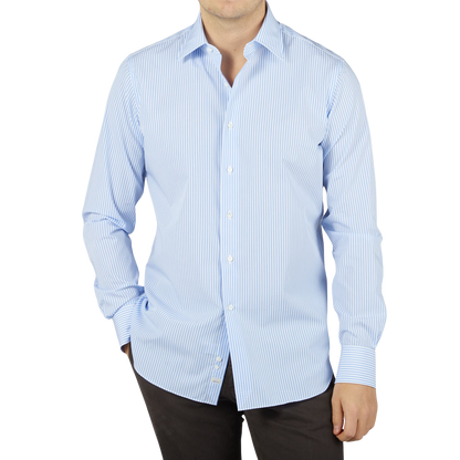 A man wearing an Alessandro Gherardi Sky Blue Striped Cotton Single Cuff Shirt.