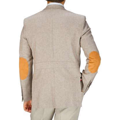 A man in Italy is seen from behind in an Alexander Kraft Monte Carlo beige herringbone wool linen Provence jacket with orange patches.