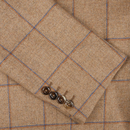 A close up of a Caramel Estate Wool Tweed Provence Jacket with blue buttons, designed by Alexander Kraft Monte Carlo.