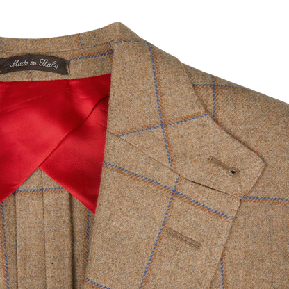 Alexander Kraft Monte Carlo's Caramel Estate Wool Tweed Provence Jacket, crafted from pure wool, is perfectly complemented with a vibrant red tie.