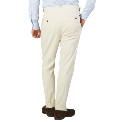 The back view of a man wearing Alexander Kraft Monte Carlo's Cream White Cotton Twill Updated Gurkha Trousers.