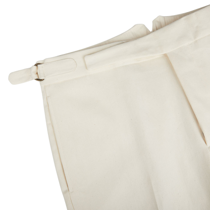 A pair of Cream White Cotton Twill Updated Gurkha Trousers from Alexander Kraft Monte Carlo with a gold buckle.