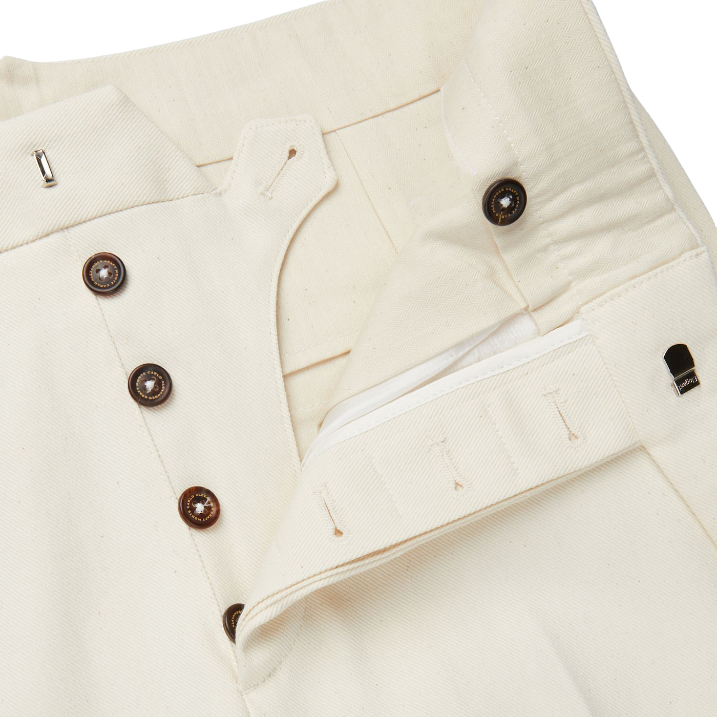 A close up of a slim-cut, Cream White Cotton Twill Updated Gurkha Trousers by Alexander Kraft Monte Carlo.