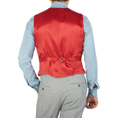 A man wearing a Light Grey VBC Wool Flannel DB Waistcoat, crafted with pure wool flannel by Alexander Kraft Monte Carlo.