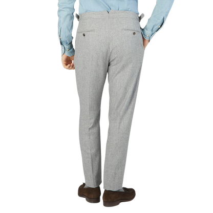 The back view of a man wearing Light Grey VBC Wool Flannel Riviera Trousers by Alexander Kraft Monte Carlo.