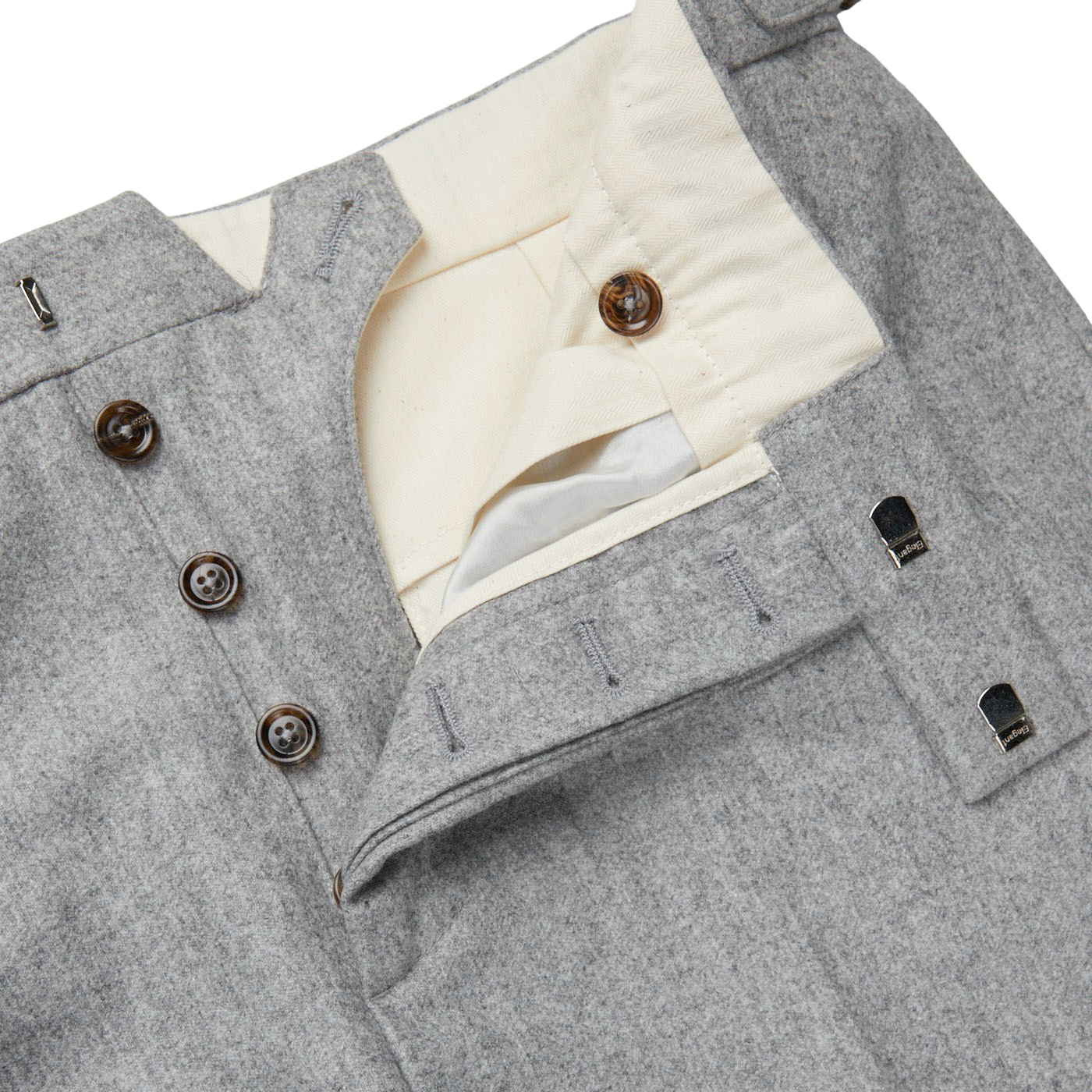 A close up of a Light Grey VBC Wool Flannel Riviera Trousers with buttons by Alexander Kraft Monte Carlo.