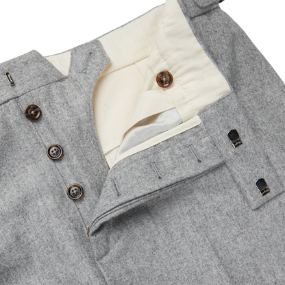 A close up of a Light Grey VBC Wool Flannel Riviera Trousers with buttons by Alexander Kraft Monte Carlo.
