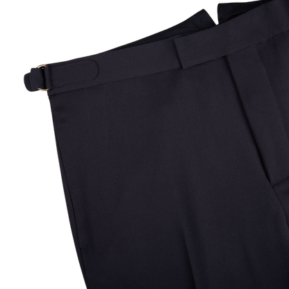 A close up of a Navy Blue Textured Worsted Wool Riviera Trouser with gold buckles by Alexander Kraft Monte Carlo.