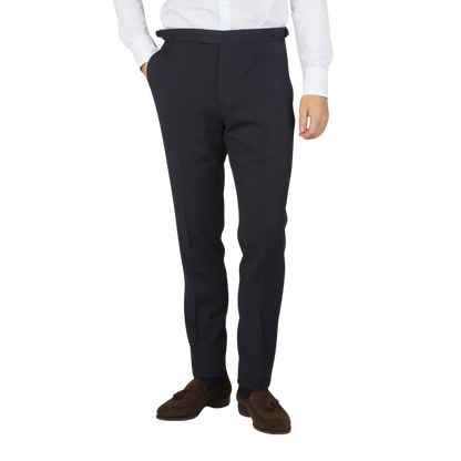 A man dressed in Alexander Kraft Monte Carlo's Navy Blue Textured Worsted Wool Riviera Trousers and a white shirt.