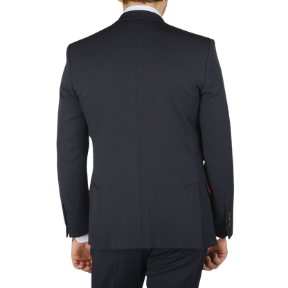 The back view of a man wearing an Alexander Kraft Monte Carlo Navy Blue Textured Worsted Wool Signature Jacket.