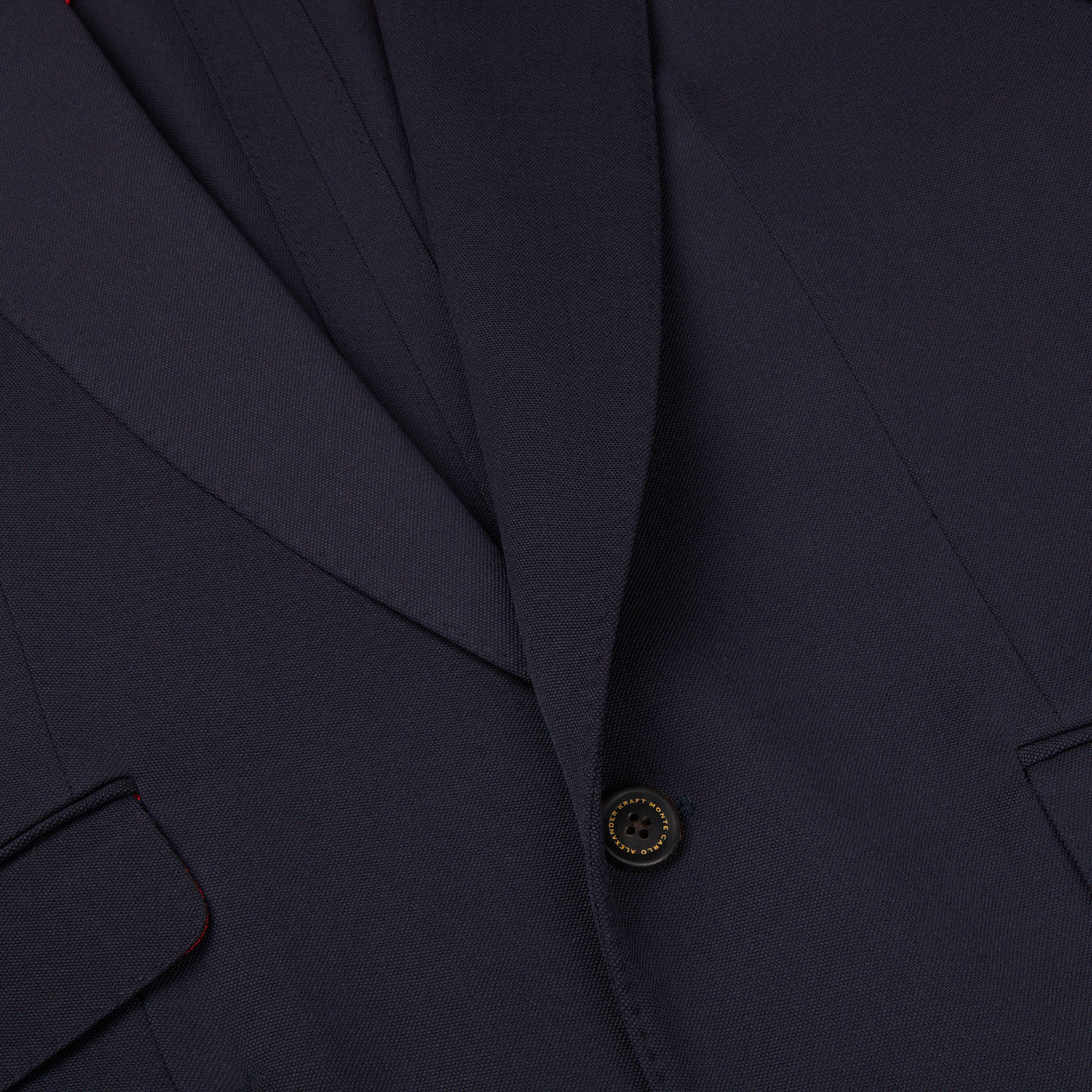 A close up of an Alexander Kraft Monte Carlo navy blue textured worsted wool signature jacket with red detailing.