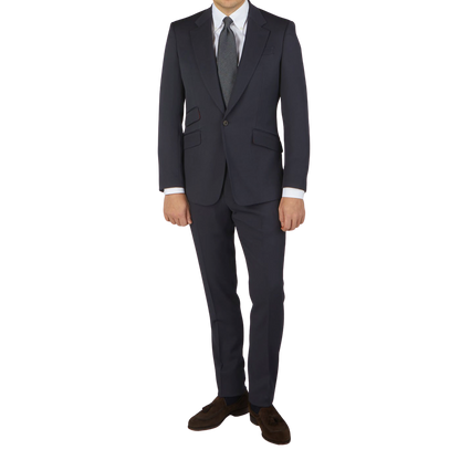 A man is posing in an Alexander Kraft Monte Carlo Navy Blue Textured Worsted Wool Signature Jacket.