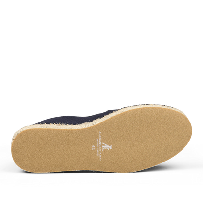 The underside of a shoe with a light brown sole features white text indicating the brand and size "42." The upper part, crafted in dark blue cotton, exudes the luxurious appeal of Alexander Kraft Monte Carlo Dark Blue Cotton Luxury Espadrilles, with only a partial view hinting at their elegance.