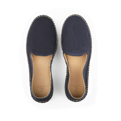 A pair of Dark Blue Cotton Luxury Espadrilles from Alexander Kraft Monte Carlo, featuring tan insoles, shown from above on a black background.