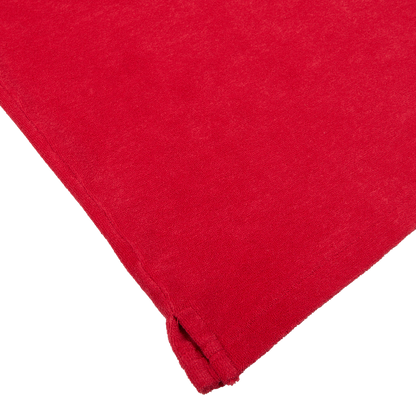 Altea Coral Red Cotton Towelling Capri Collar Polo Shirt fabric with a neatly folded edge on a white background.