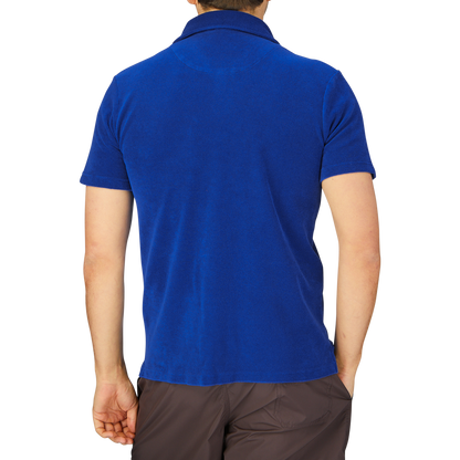 Rear view of a person wearing a dark blue Altea Organic Cotton Capri Collar Polo Shirt and brown trousers.