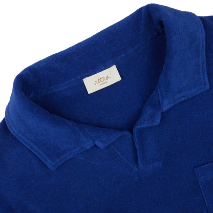 Close-up of a dark blue Altea Cotton Towelling Capri Collar Polo Shirt with a visible brand label on the collar.