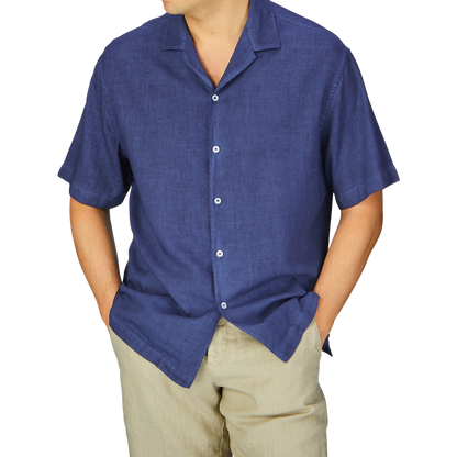 Man in a Dark Blue Linen Blend Open Collar Shirt and beige pants with hands in pockets, embodying a summer essential look by Altea.