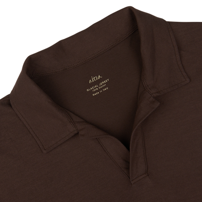 Close-up of a dark brown Altea Cotton Jersey Capri Collar Polo Shirt with a tag showing the brand and material details of the seasonal polo shirt.