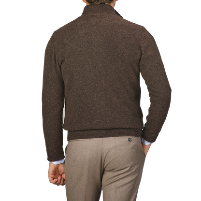 Man standing with his back to the camera, wearing an Altea Dark Brown Shetland Wool Button Cardigan and light brown pants.