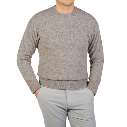 A man wearing an Altea Grey Melange Wool Alpaca Crewneck Sweater.