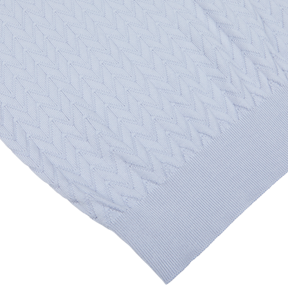 Light blue Altea pure cotton textured fabric overlaying a smooth white surface.