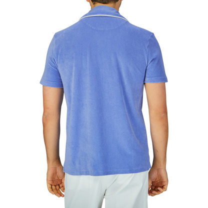 Man from behind wearing an Altea light blue cotton  Towelling Capri collar shirt and white trousers.