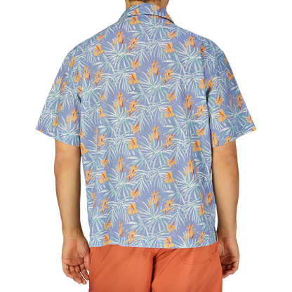 A person viewed from behind wearing an Altea light blue floral printed cotton shirt and orange shorts.