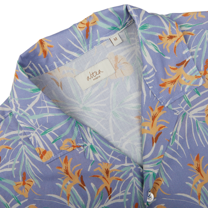 Close-up of a Light Blue Floral Printed Cotton Altea shirt with a visible brand label at the collar, a summer essential.