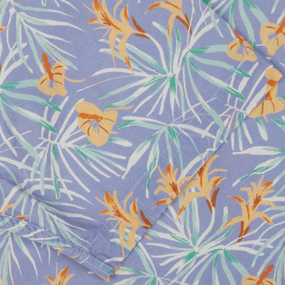 A close-up of an Altea Light Blue Floral Printed Cotton Shirt with a tropical design, featuring palm leaves and butterflies on a lavender background, perfect as a summer essential.