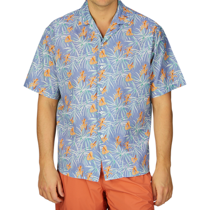 A person wearing a Light Blue Floral Printed Cotton Shirt by Altea and orange pants, a summer essential outfit.