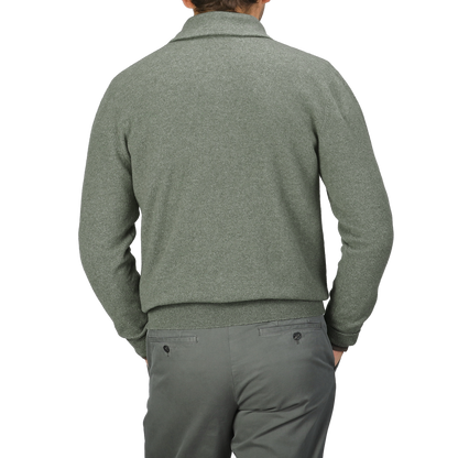 Person wearing an Altea Moss Green Wool Fleece 1/4 Zip Sweater and gray pants, facing away.