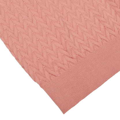 Close-up of a Muted Pink Cotton Capri Collar Polo Shirt by Altea with a chevronne knit pattern on top and a ribbed texture below.
