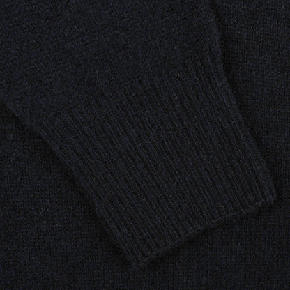 Close-up of the ribbed cuff on the sleeve of an Altea Navy Blue Shetland Wool Button Cardigan, crafted from luxurious Shetland wool.