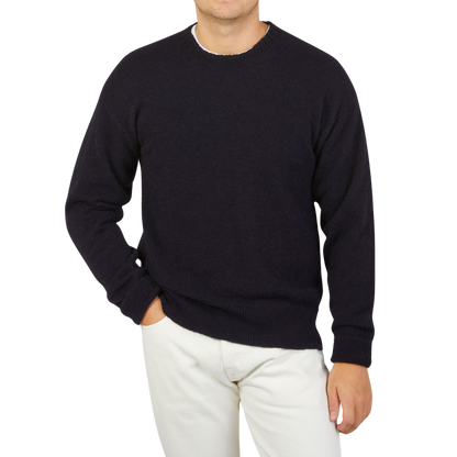 A man wearing a seasonal Navy Blue Wool Alpaca crewneck sweater by Altea.