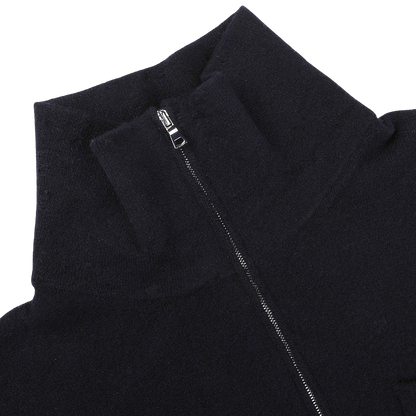 Close-up of a navy blue, wool fleece 1/4 zip sweater by Altea with a partially unzipped silver zipper on a plain white background.