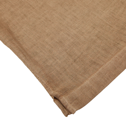 A close-up of a folded Altea Tobacco Brown Linen Blend Camp Collar Shirt with a textured weave on a white background.