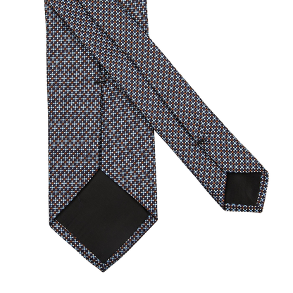 A close-up shot of a Amanda Christensen Dark Brown Blue Dot Silk Lined Tie.