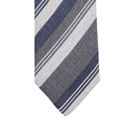 A close up of a Blue Grey Striped Silk Lined Tie by Amanda Christensen.