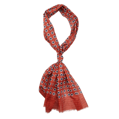 A patterned orange and white Amanda Christensen scarf with fringe on a white background.